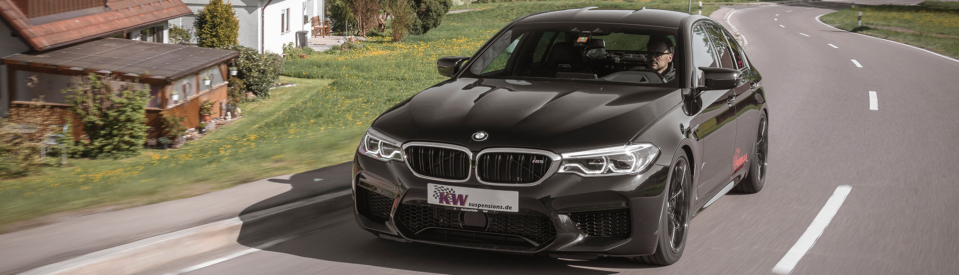 BMW M5 (F90) with KW coilover Variant 4 driving on the road  . 